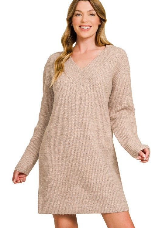 Woman wearing a beige sweater dress on a white background