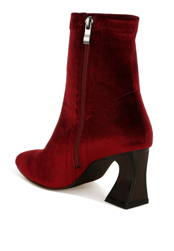 Red ankle boot with a zipper on a white background