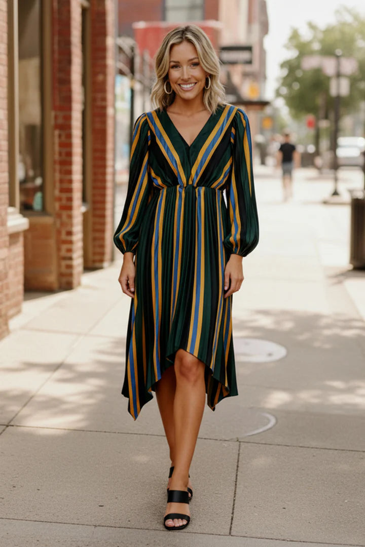 Woman in a striped dress walking on a city street