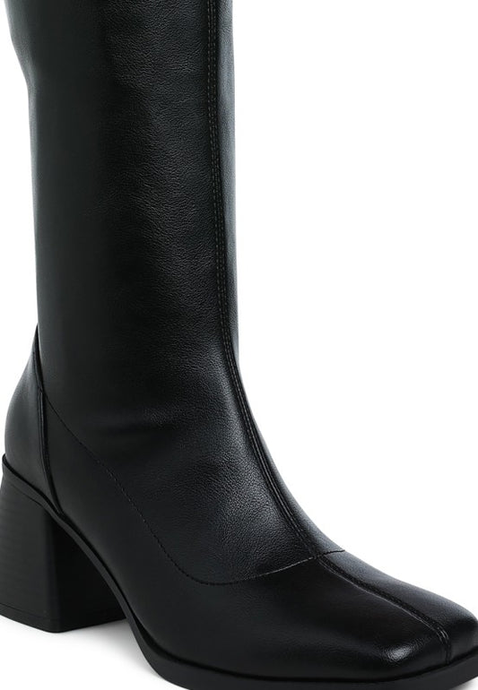 Black knee-high boot with a block heel on a white background