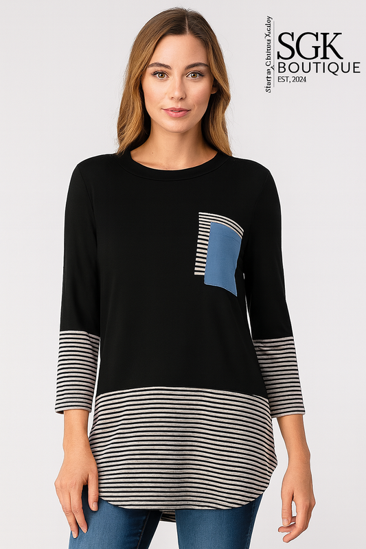 Woman wearing a black and striped long-sleeve top with a blue pocket, standing against a white background. SGK Boutique logo visible.