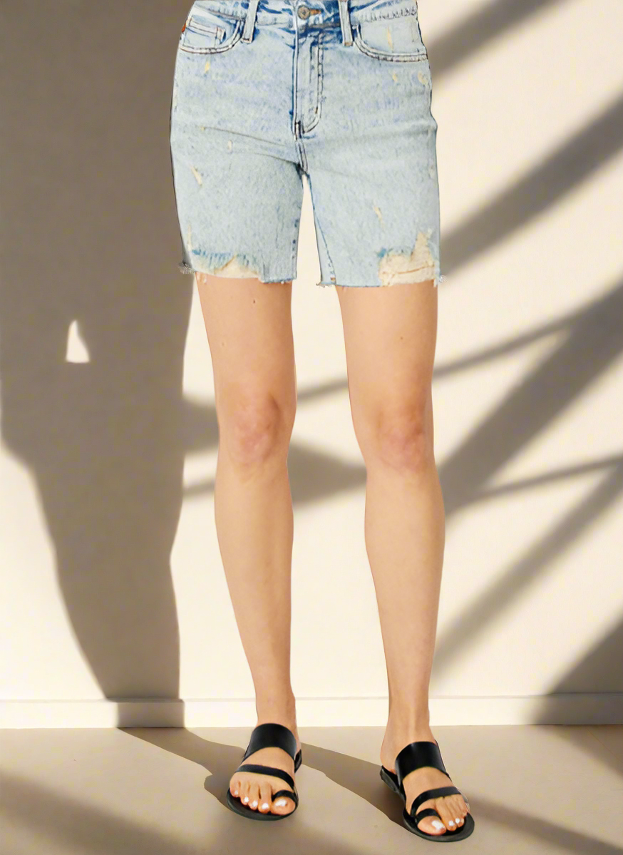 Light blue denim shorts worn by a person on a white background