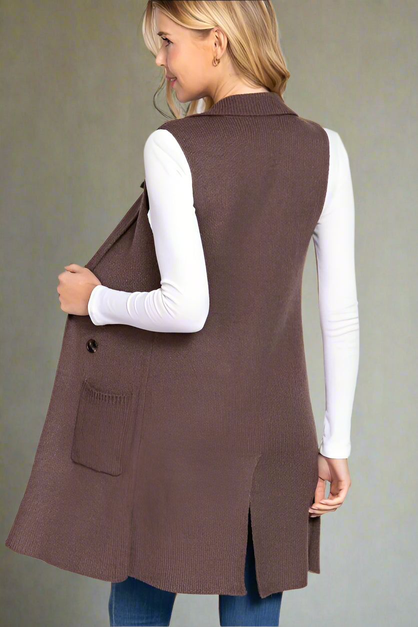 Woman wearing a brown vest over a white shirt on a white background