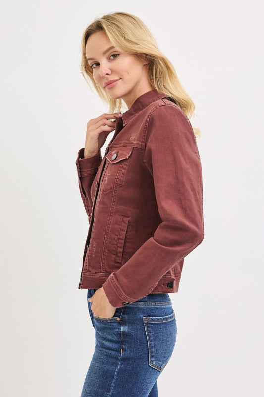 Woman wearing a brown jacket and blue jeans on a white background
