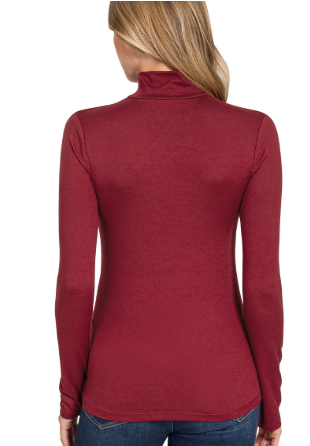 Burgundy long-sleeve top worn by a person on a white background