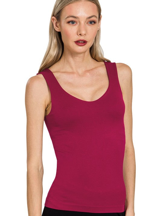 Woman wearing a cabernet tank top against a white background