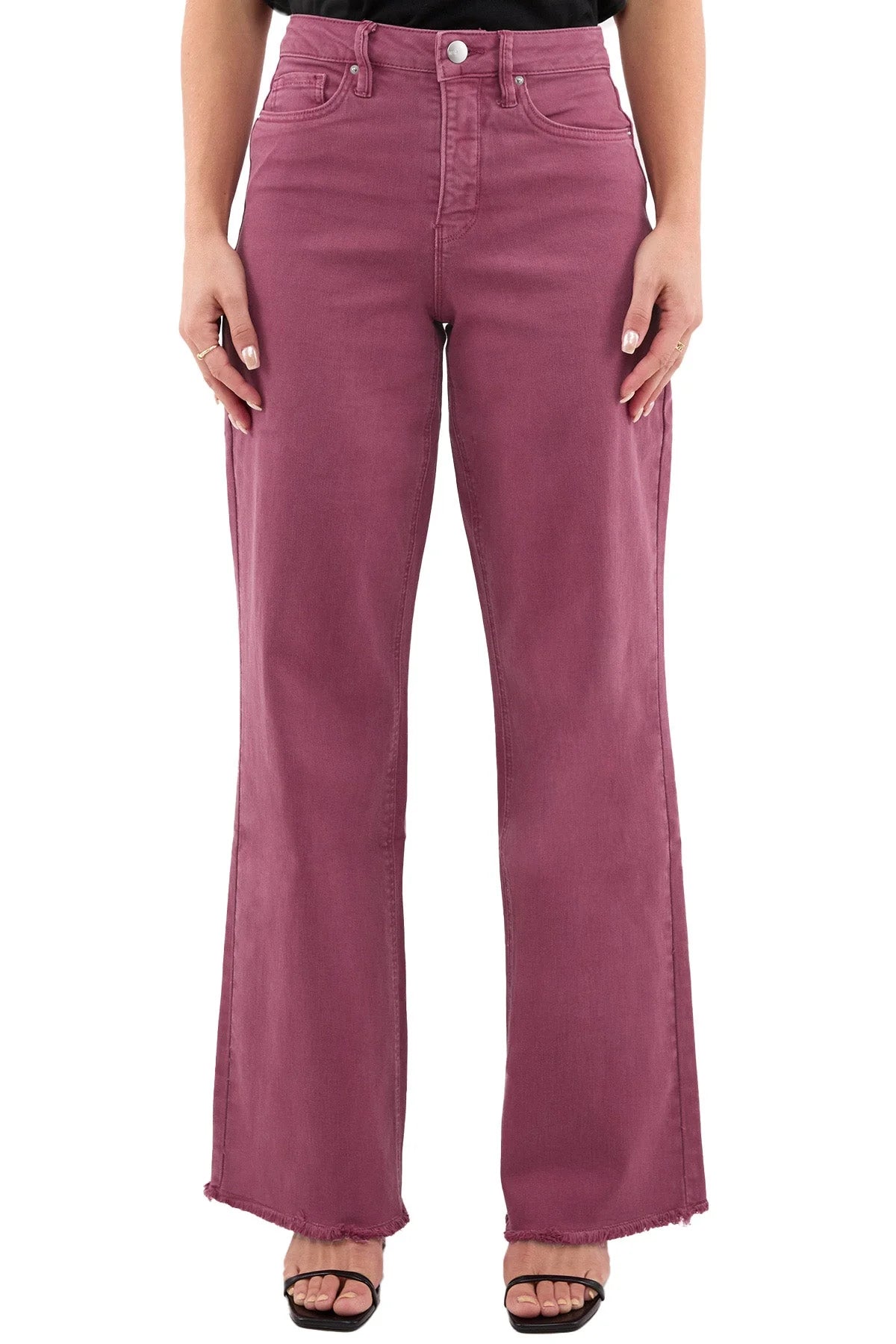 Maroon jeans worn by a person on a white background