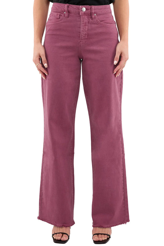 Maroon jeans worn by a person on a white background