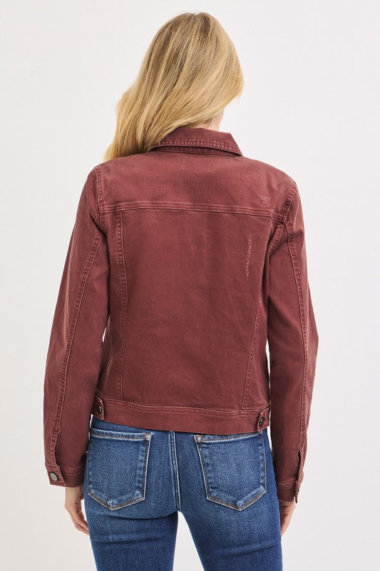 Person wearing a Brown jacket and blue jeans on a white background