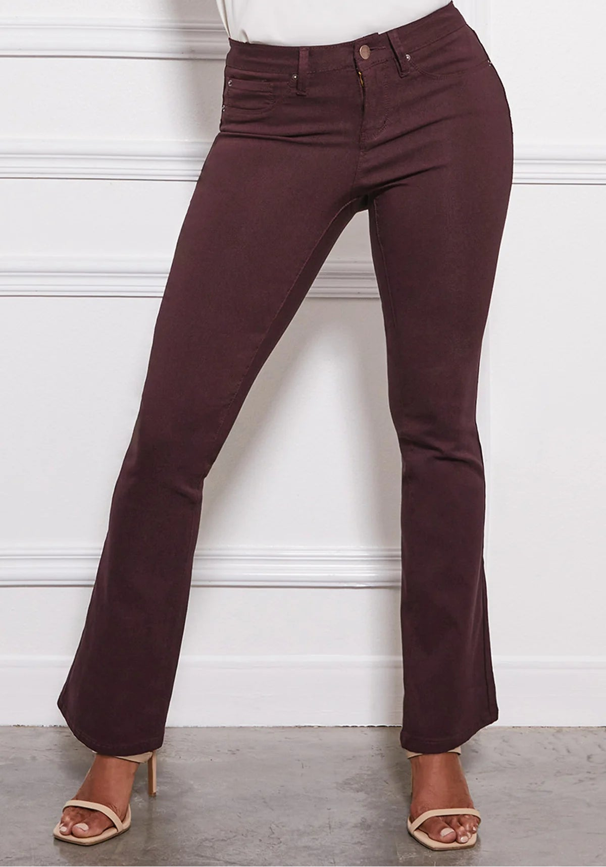 Maroon pants worn by a person against a white background