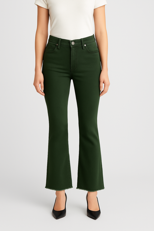 Person wearing green flared jeans on a white background