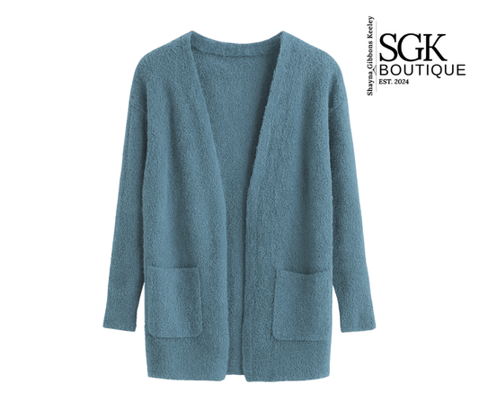 Blue cardigan on a white background with SGK Boutique logo.