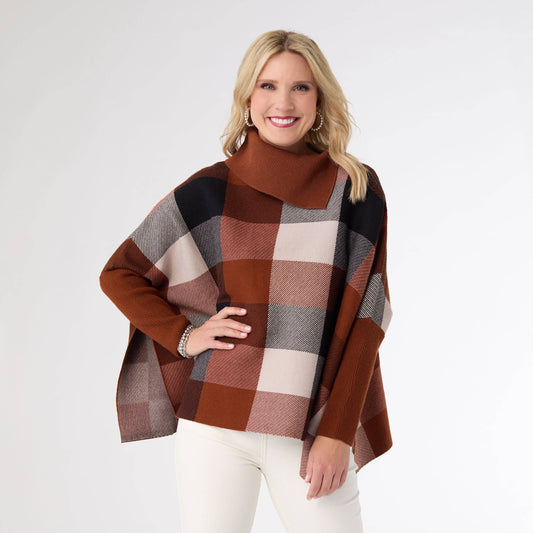 Woman wearing a plaid poncho with a white background
