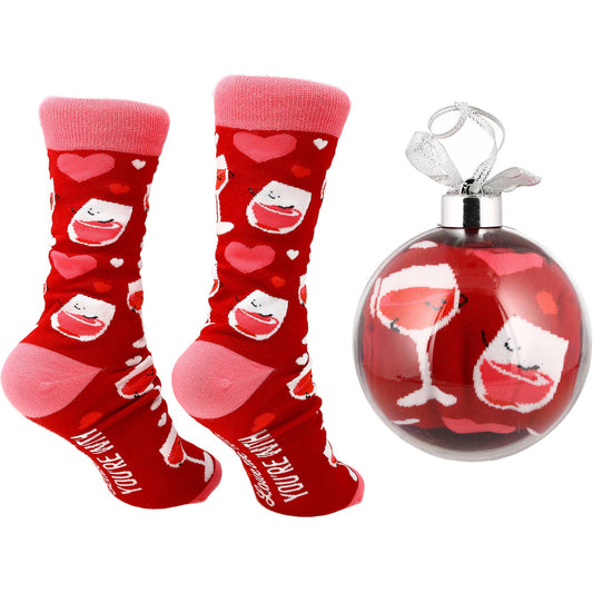 Red socks with heart and face designs and a matching ornament on a white background