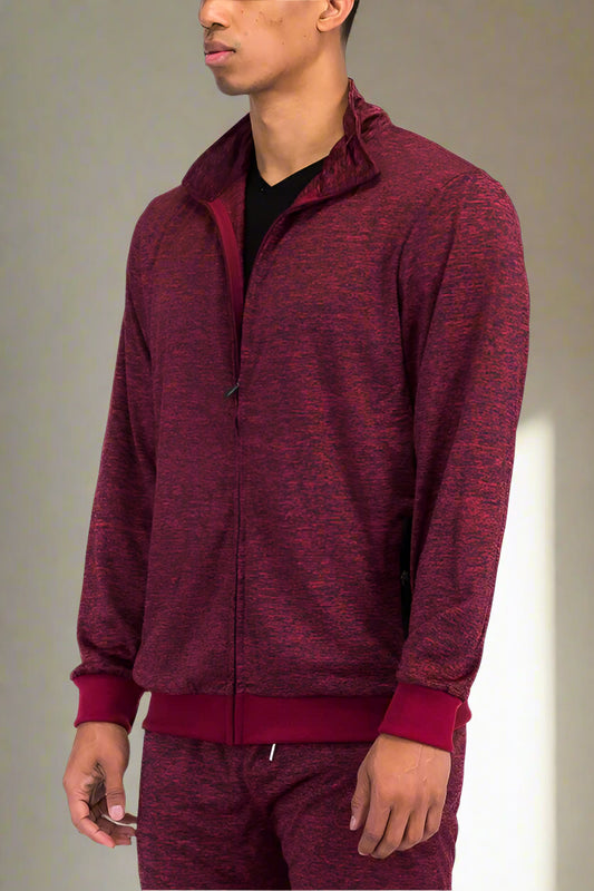 Maroon tracksuit worn by a person on a white background