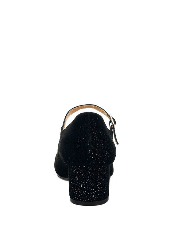 Black pump with strap on a white background