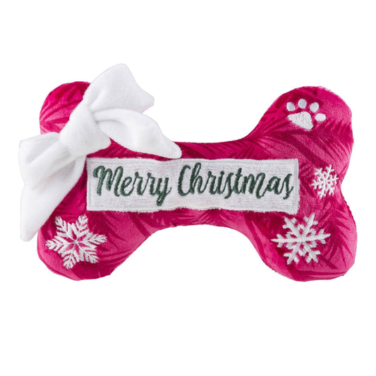 Pink bone-shaped Christmas toy with a white bow and 'Merry Christmas' label on a white background