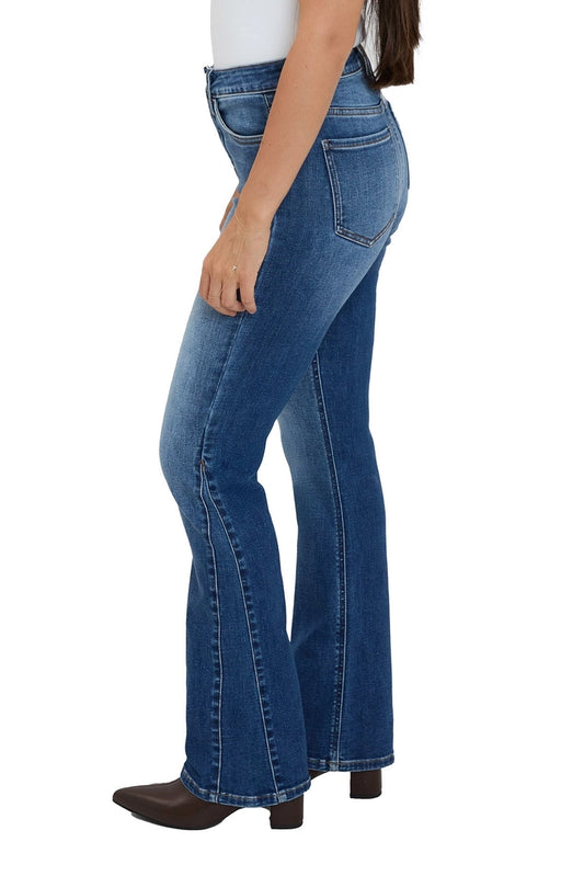 Blue flared jeans worn by a person on a white background