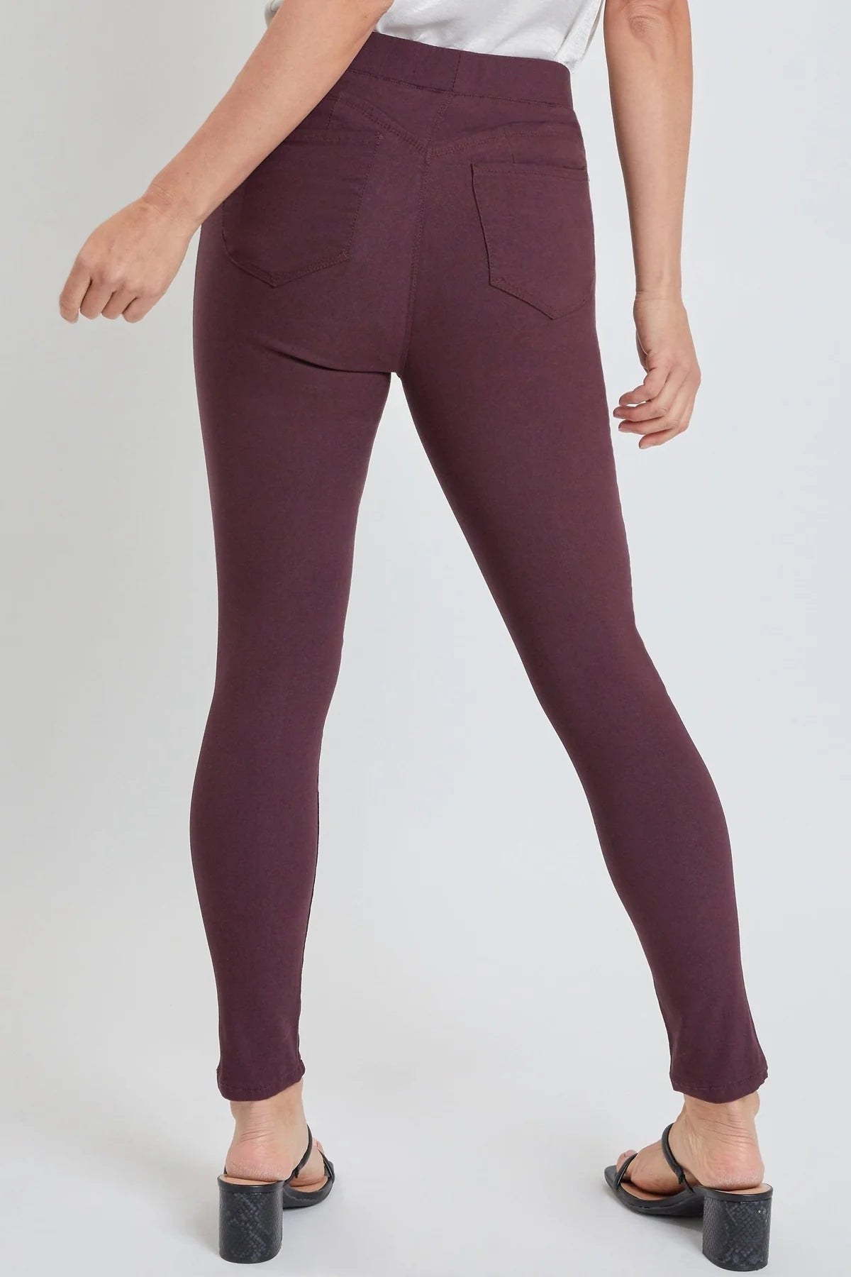 Maroon pants worn by a person on a white background