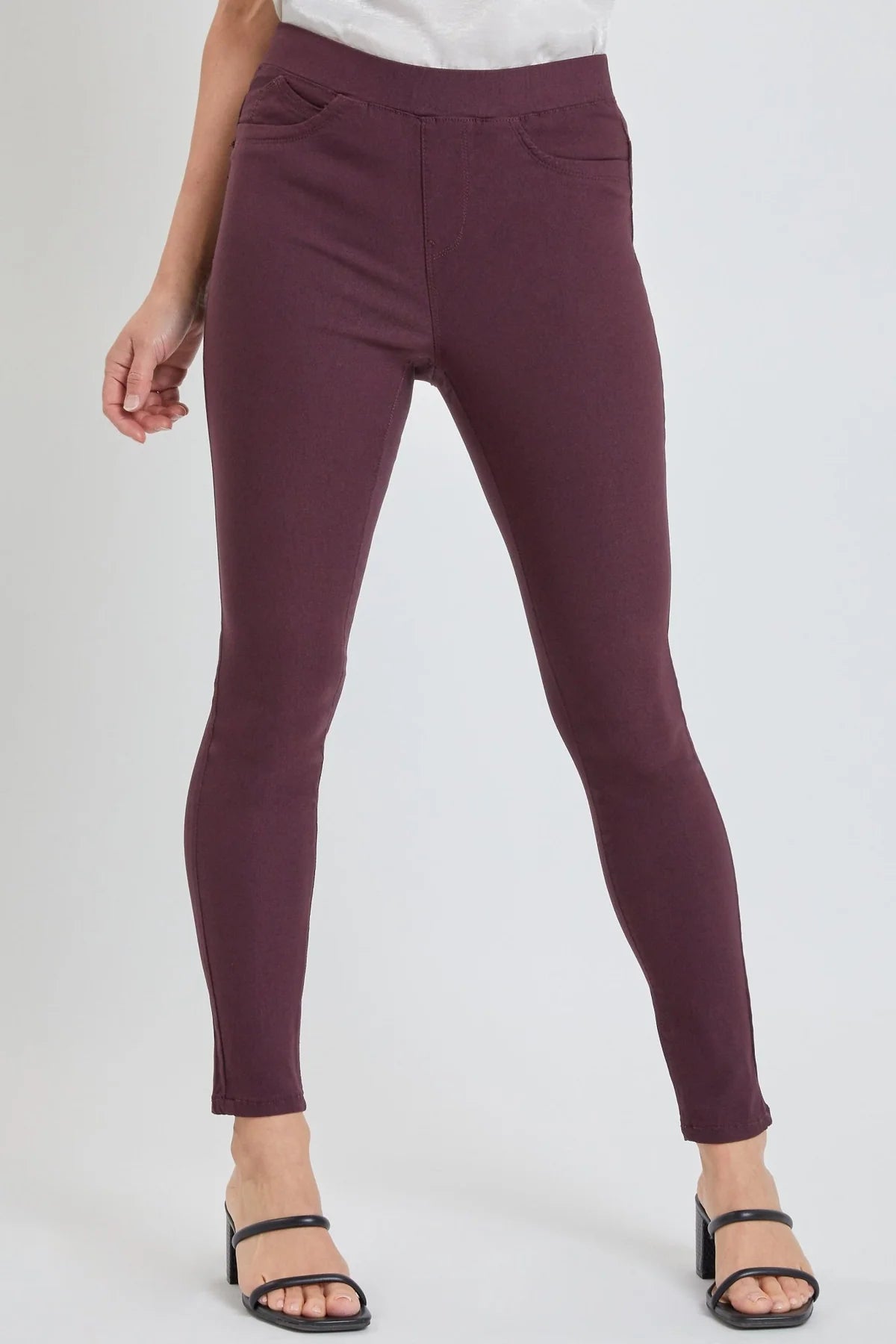 Purple pants worn by a person on a white background