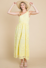 A model wearing a yellow one-shoulder maxi dress with lace details, paired with a wide-brimmed hat.