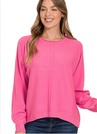 Woman wearing a pink sweater on a white background