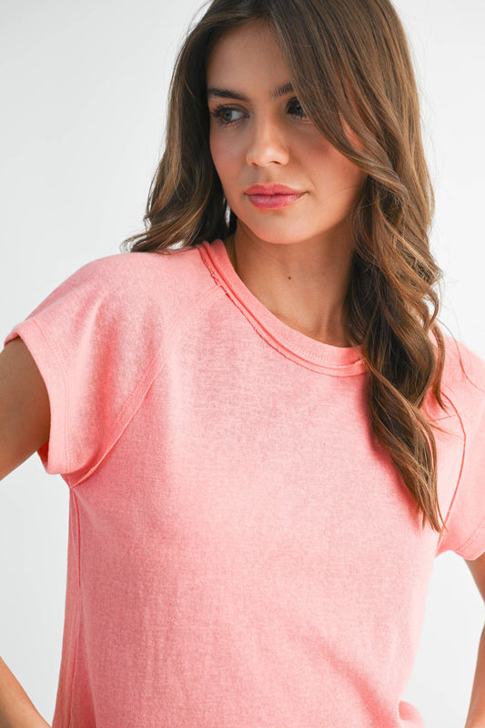 Woman wearing a pink t-shirt against a white background