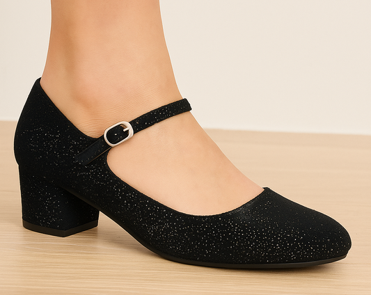 Black glittery shoe with a block heel on a beige background