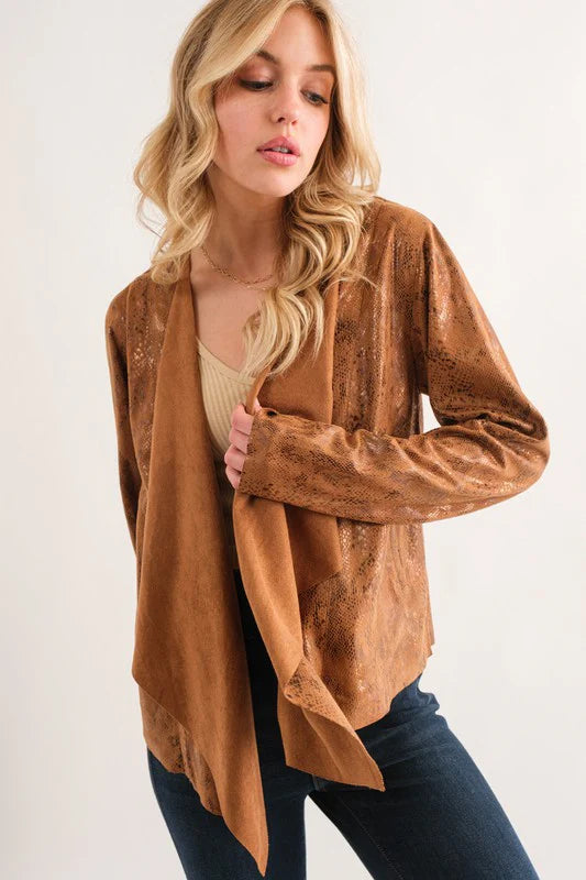 Woman wearing a brown suede jacket on a white background