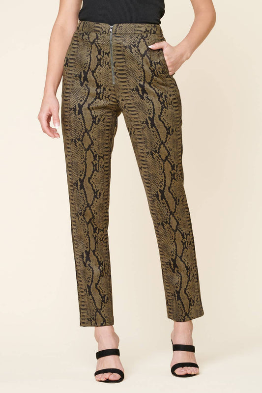 Snakeskin-patterned pants worn by a person on a beige background