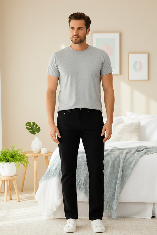 Man wearing a gray t-shirt and black pants on a white background