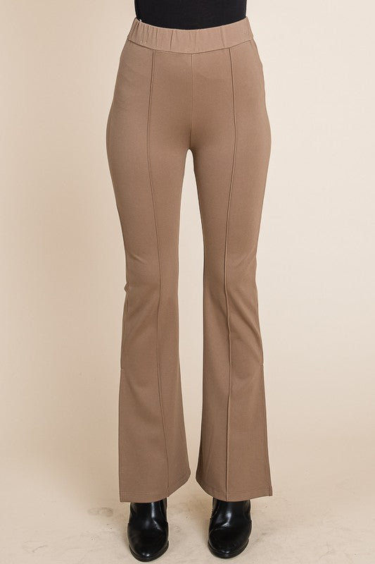 Beige flared pants on a beige background