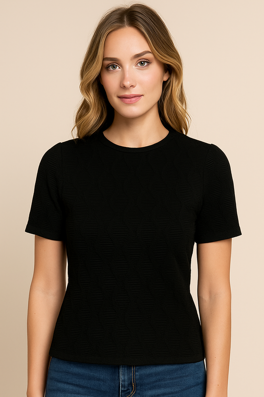 Woman wearing a black t-shirt against a beige background