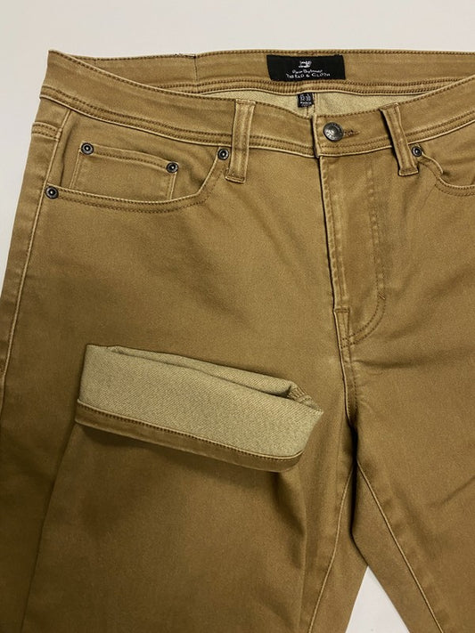 Brown pants with a visible brand label on a white background