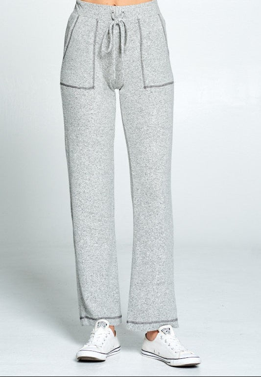 Gray sweatpants worn by a person on a white background