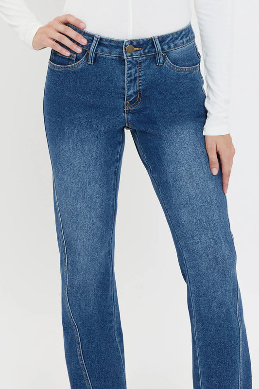 Blue jeans worn by a person on a white background