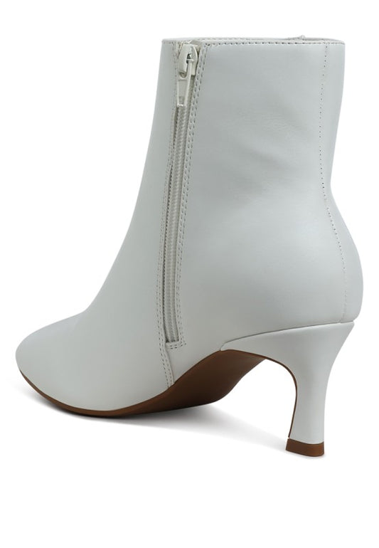 White ankle boot with a zipper on a white background