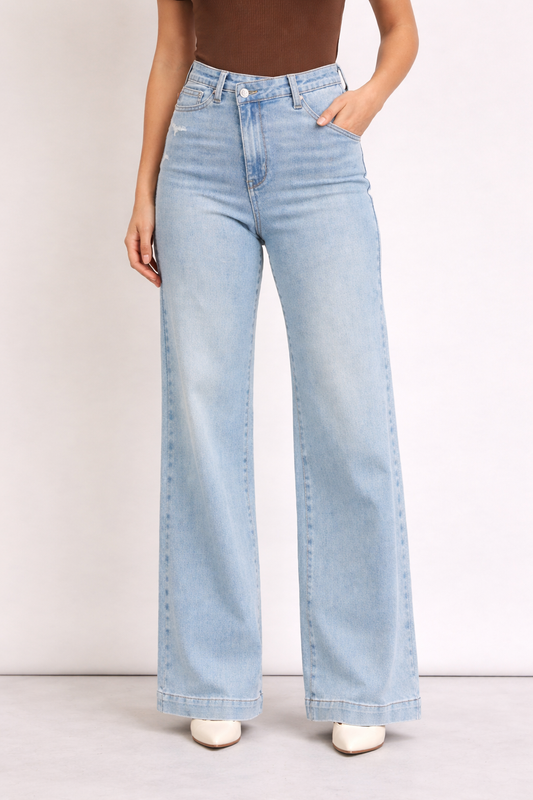 Light blue jeans worn by a person on a plain background