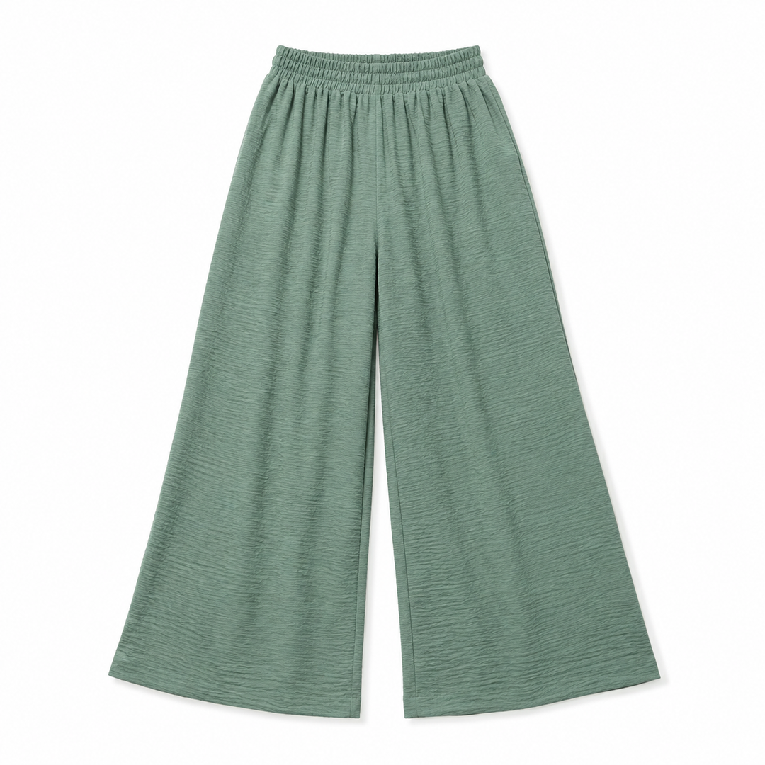 A pair of wide-leg cropped pants in a textured sage green fabric, featuring an elastic waistband, shown flat on a white background.