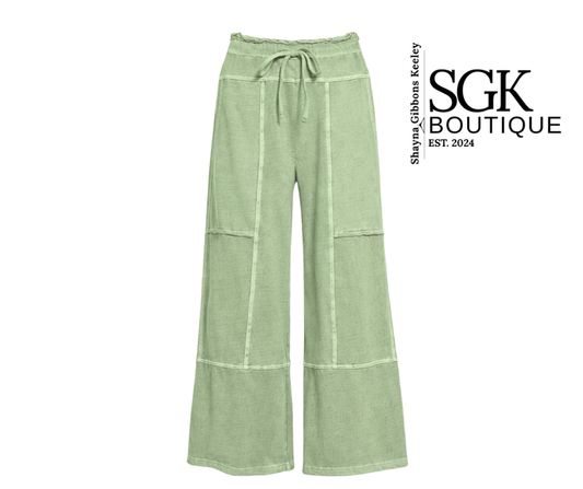 Olive green wide-leg pants with a tie waist on a white background, featuring the SGK Boutique logo.