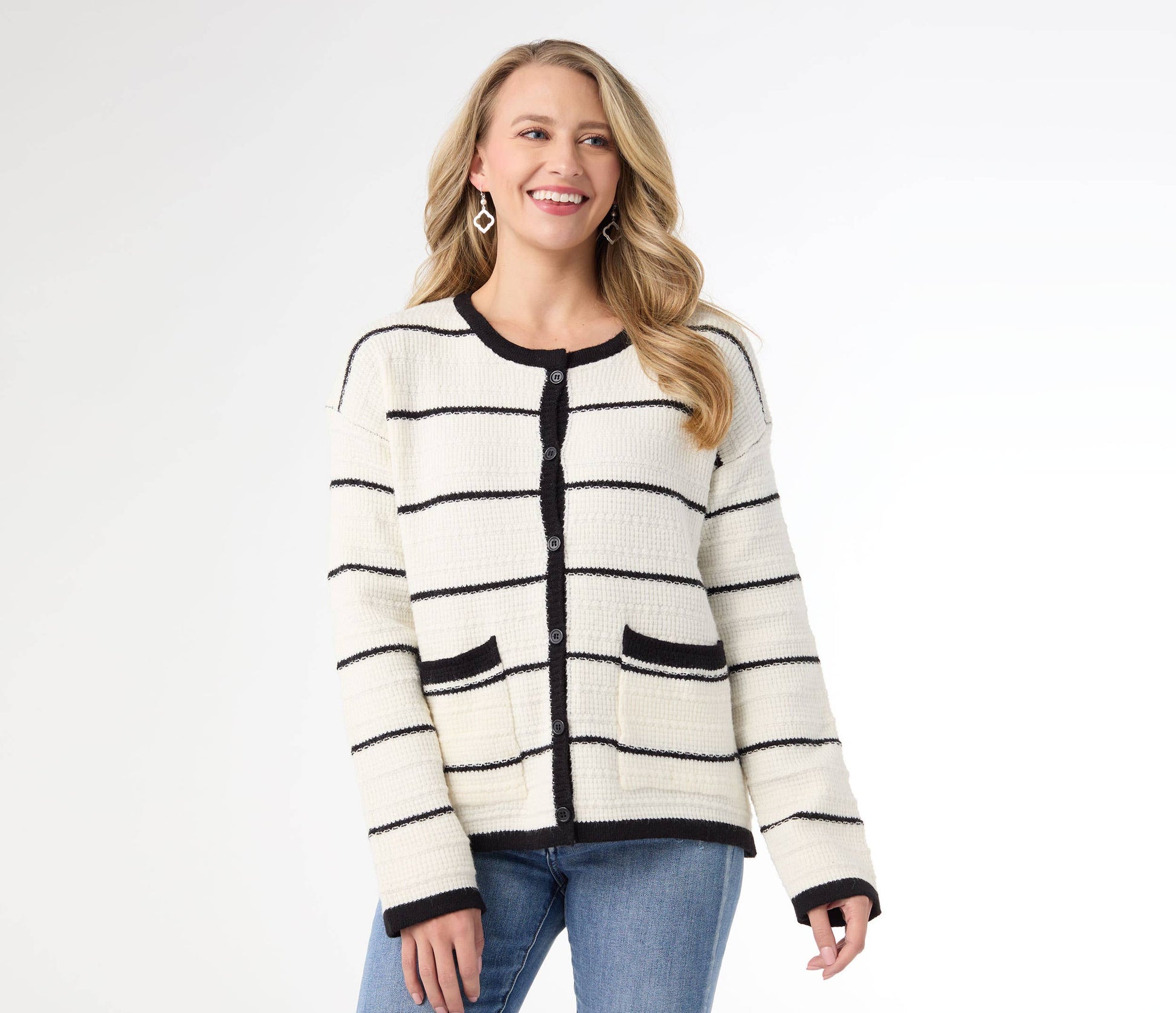 Woman wearing a striped cardigan and jeans on a white background