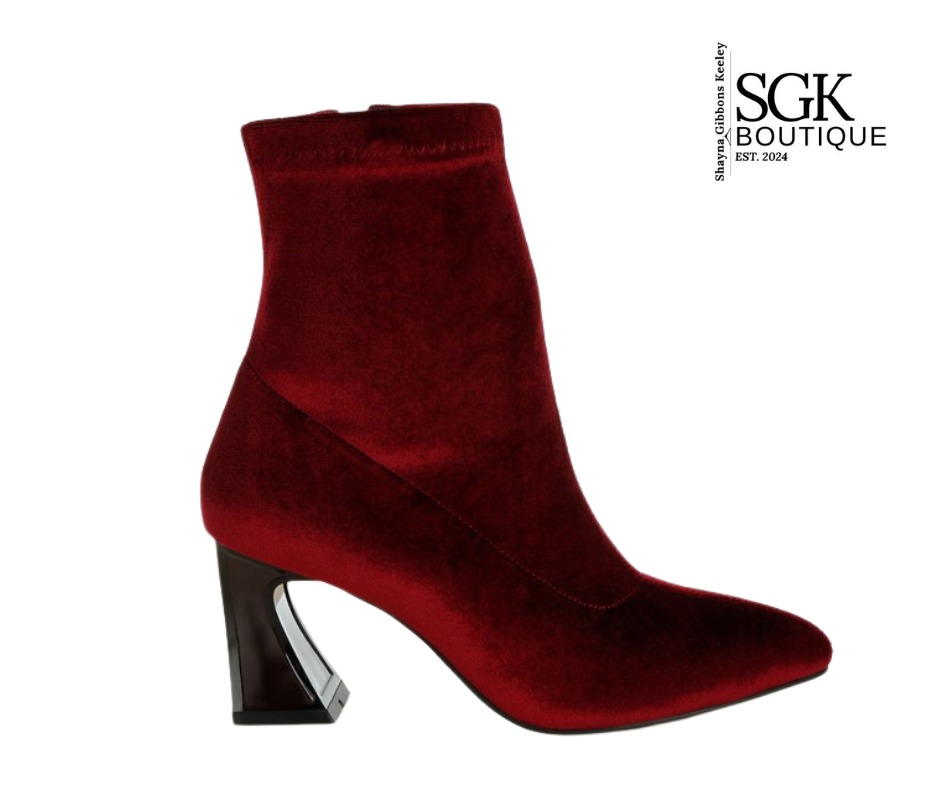 Red ankle boot with a black heel on a white background, featuring the SGK Boutique logo.
