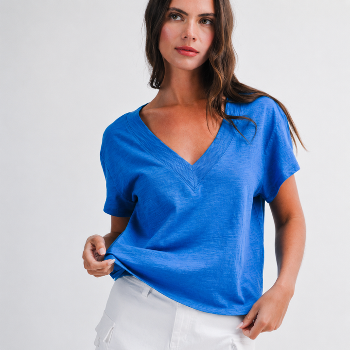 Woman wearing a blue top against a white background