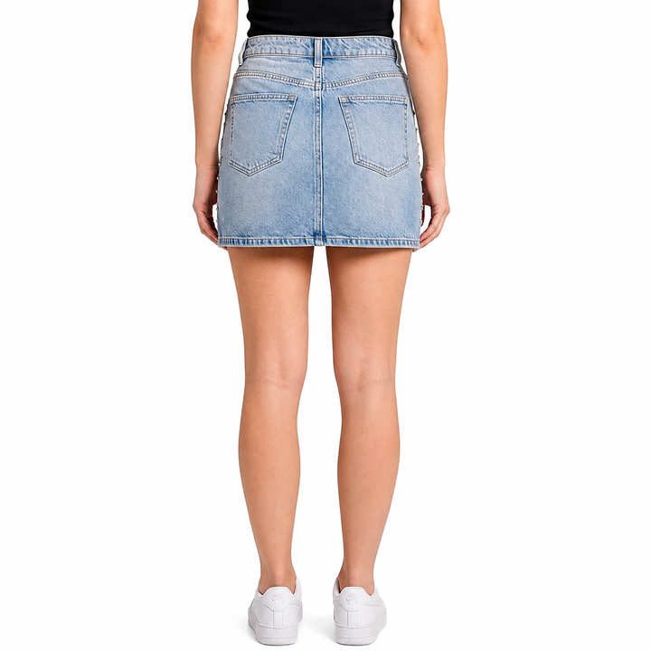 Light blue denim skirt worn by a person on a white background