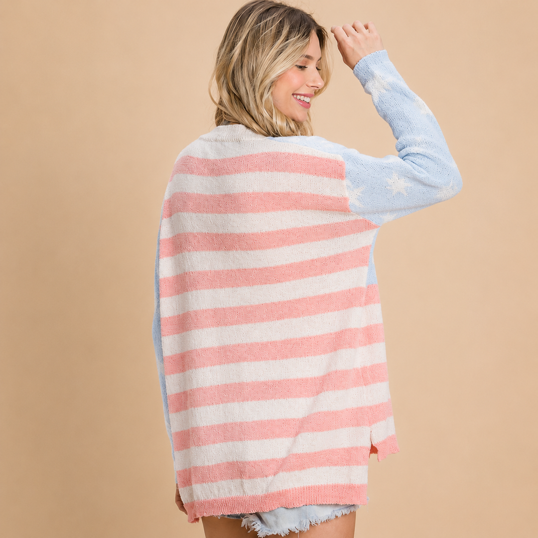 Woman wearing a pink and white striped sweater over a light blue shirt on a beige background