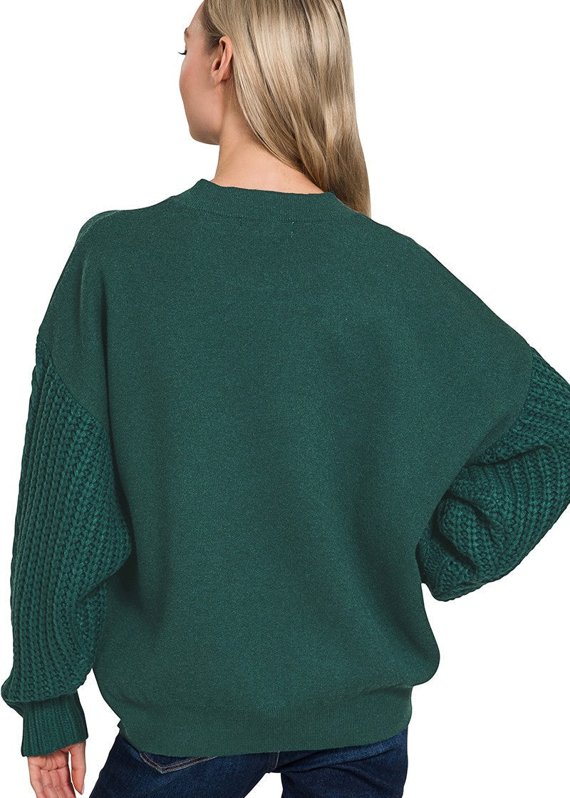 Green sweater worn by a person on a white background