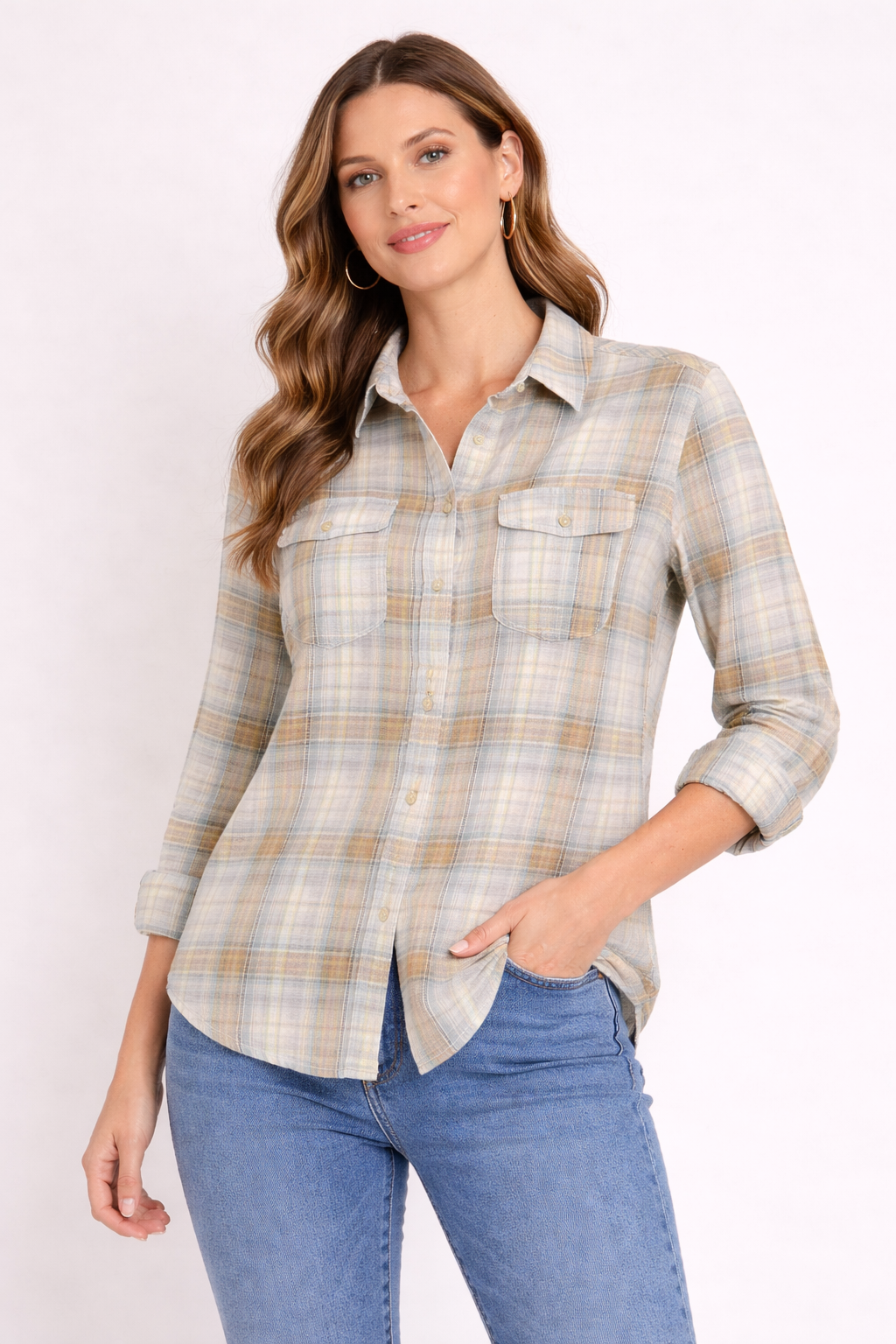 Woman wearing a plaid shirt and jeans against a white background