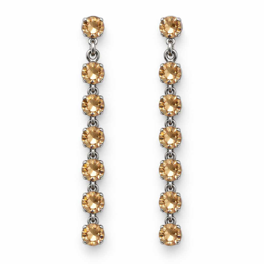A pair of silver drop earrings, each featuring seven round-cut, warm golden-brown gemstones set in silver, displayed against a solid white background.