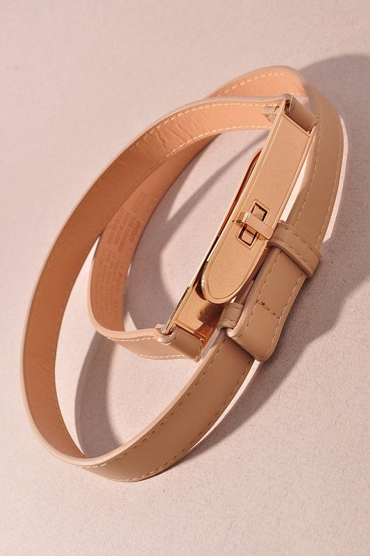 Beige leather belt with a gold buckle on a beige background