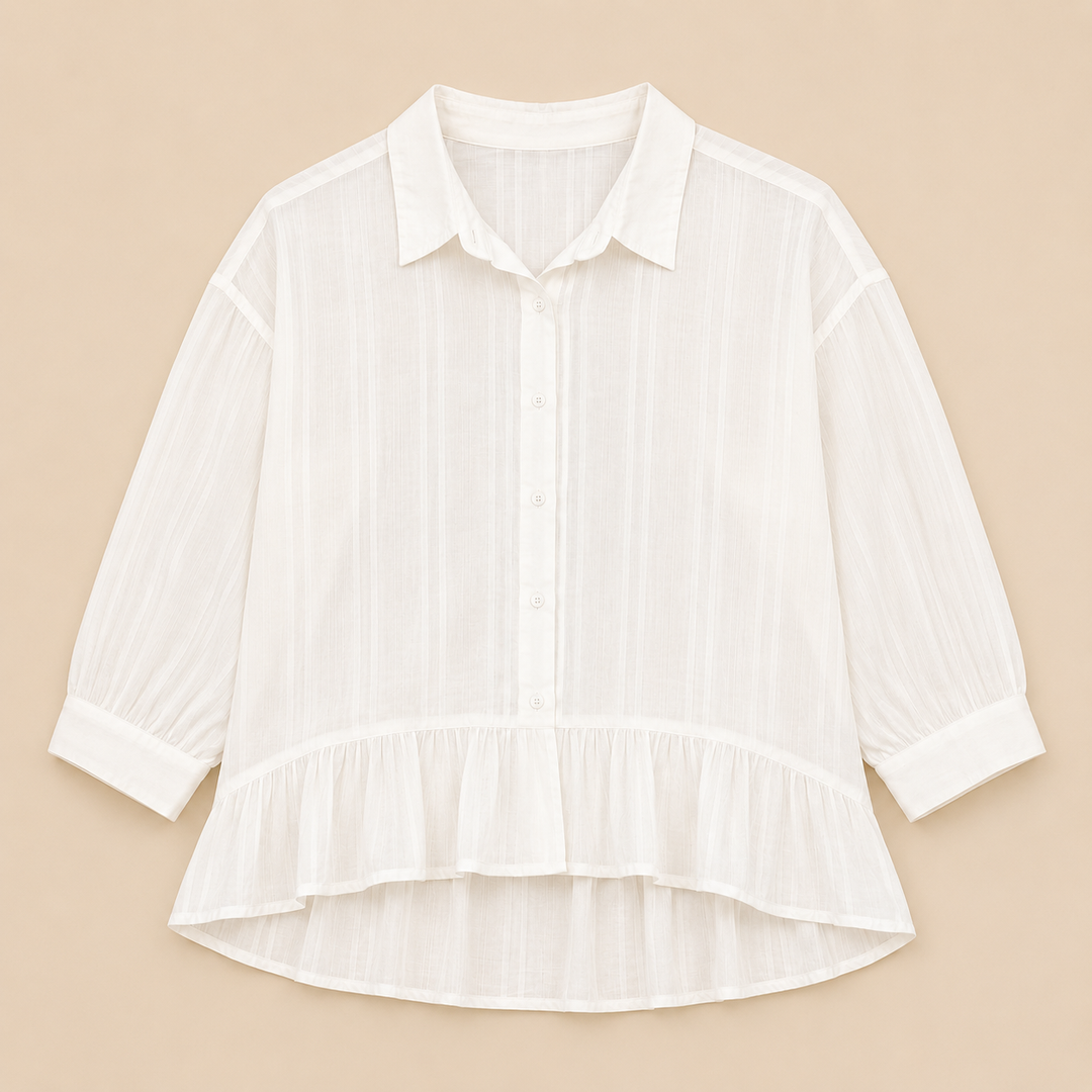 White blouse with ruffled hem on a beige background